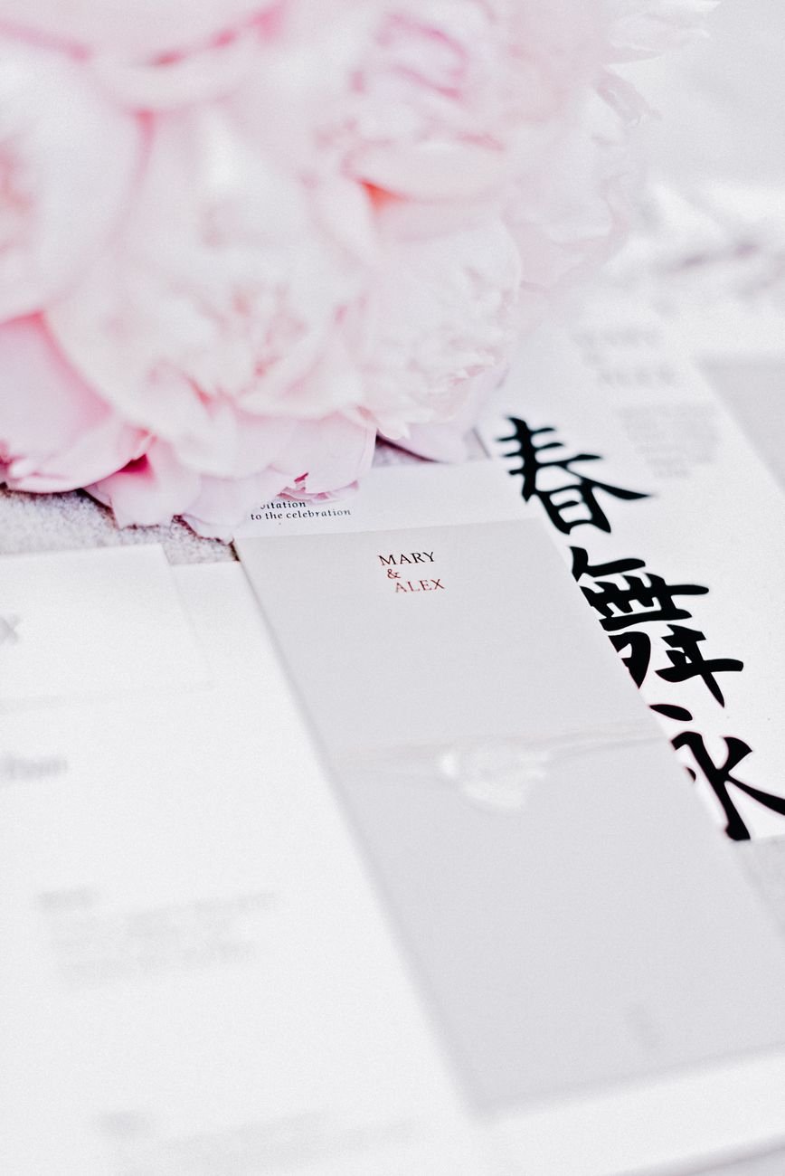 Stylish wedding invitation with pink peonies and elegant typography